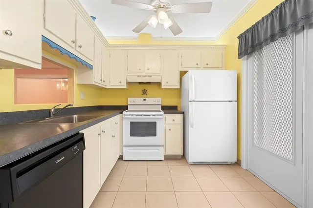 a kitchen with a white cabinets and white appliances