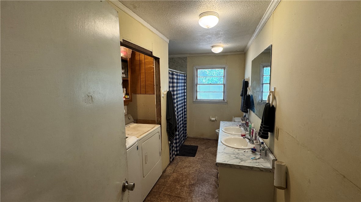 101 Due West Road Belton, SC 29627 - Photo 12 of 22 Double vanity sinks and a combined laundry area elevate daily routines.