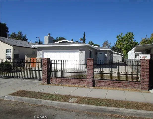 a view of a house with a iron gate
