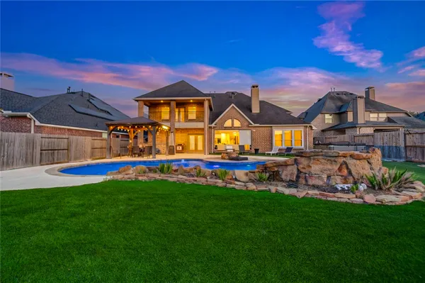 a view of a big house with a big yard