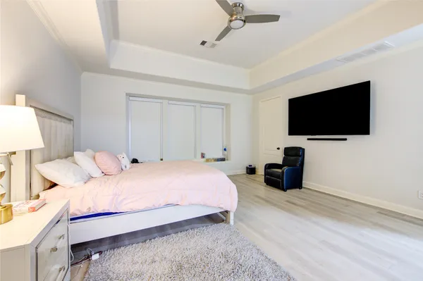 a large kitchen with cabinets wooden floor and stainless steel appliances