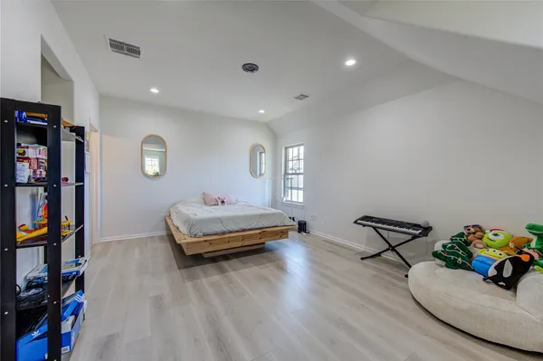a bedroom with a bed and a dresser