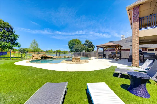 a kitchen with stainless steel appliances granite countertop a sink and a stove