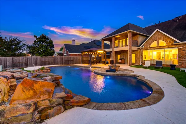 a view of a swimming pool with chair and tables