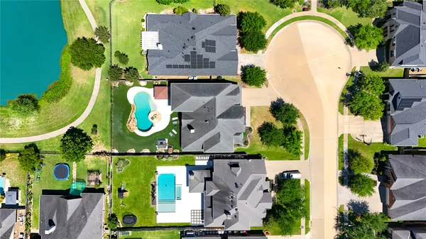 an aerial view of a house with a swimming pool