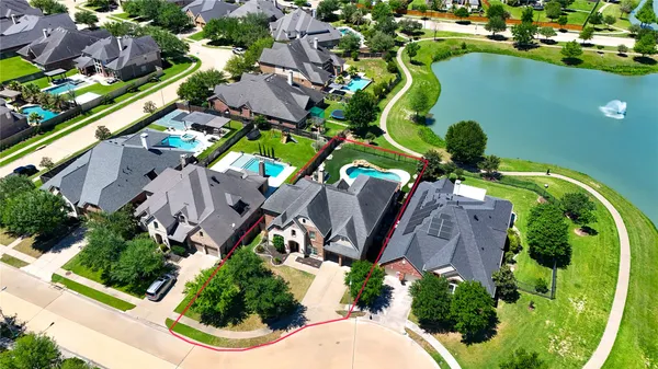 an aerial view of a house with a garden and swimming pool