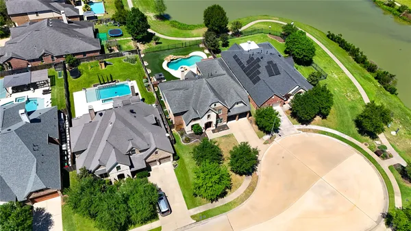 an aerial view of a house with a swimming pool