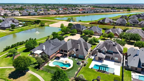 an aerial view of residential houses with outdoor space and river