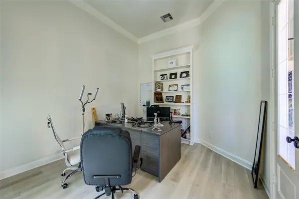 a view of a workspace with furniture and a window