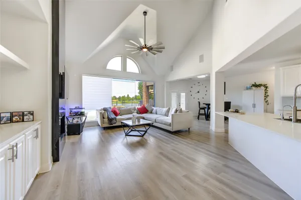 a living room with furniture and a chandelier