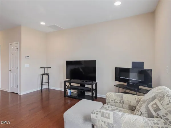 a living room with furniture and a wooden floor