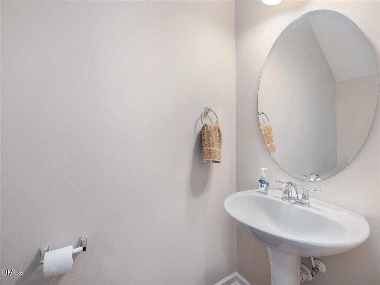 409 Provincial Street Raleigh, NC 27603 - Photo 21 of 44 a bathroom with a sink and a mirror