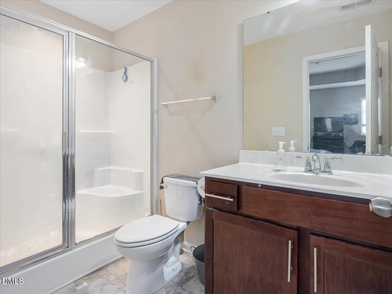 409 Provincial Street Raleigh, NC 27603 - Photo 27 of 44 a bathroom with a sink a toilet and shower
