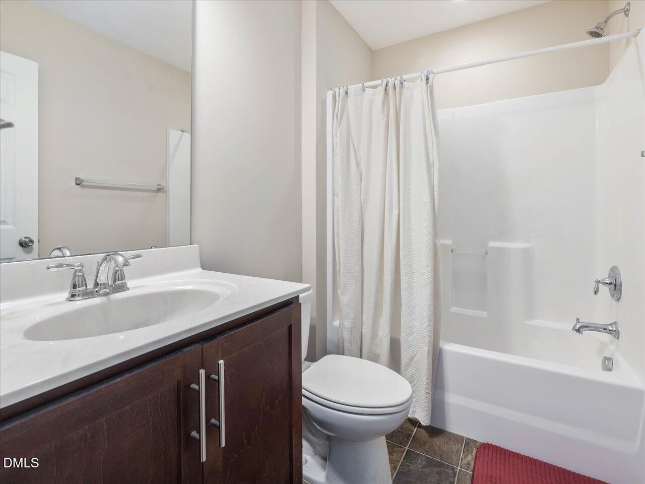 409 Provincial Street Raleigh, NC 27603 - Photo 30 of 44 a bathroom with a sink a toilet and a bathtub