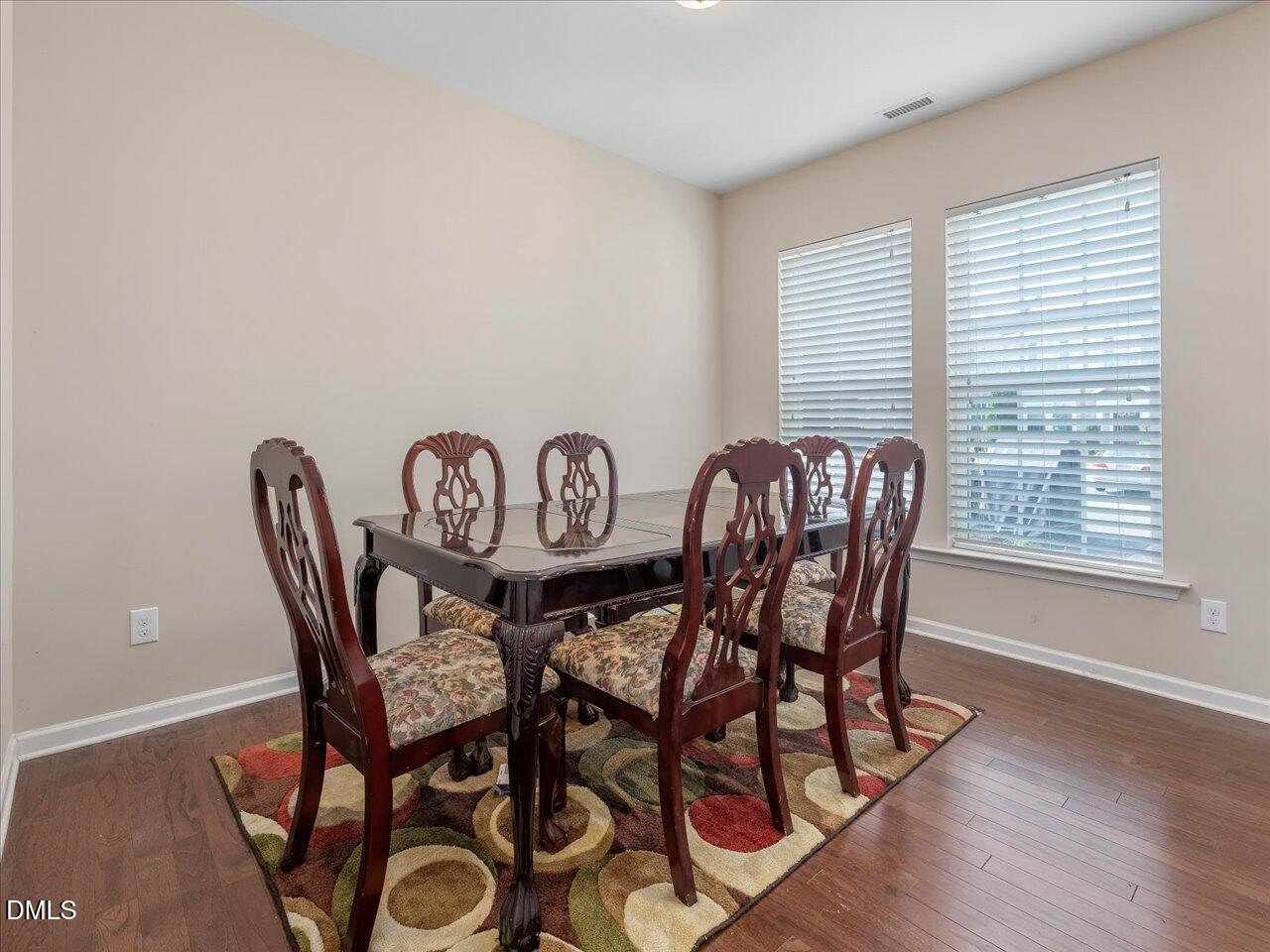 409 Provincial Street Raleigh, NC 27603 - Photo 8 of 44 a view of a dining room with furniture window and wooden floor