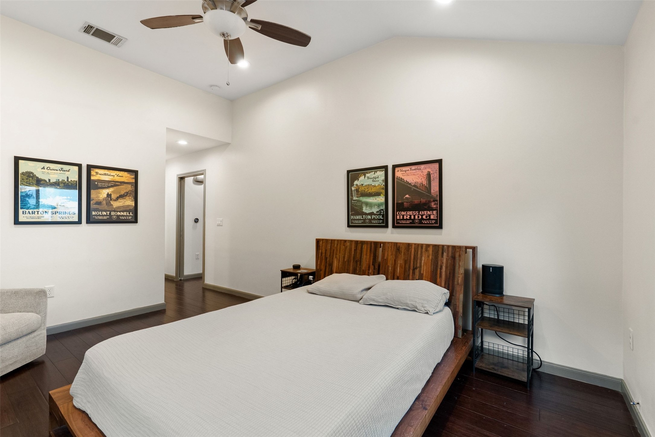 1158 Ridgeway Drive, Unit A Austin, TX 78702 - Photo 12 of 28 Vaulted ceilings and rich wood flooring elevate this primary bedroom to a peaceful retreat.