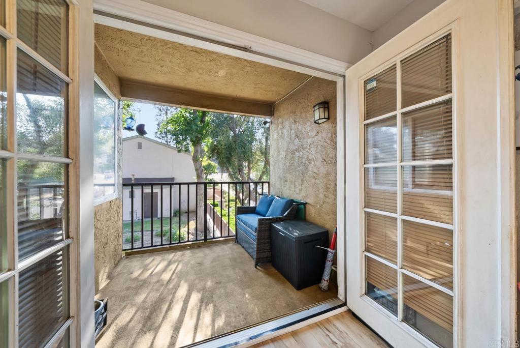 1280 West Main Street, Unit 42 El Cajon, CA 92020 - Photo 19 of 43 a view of a balcony with chairs and floor to ceiling window
