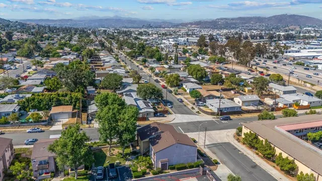 an aerial view of residential houses with city view
