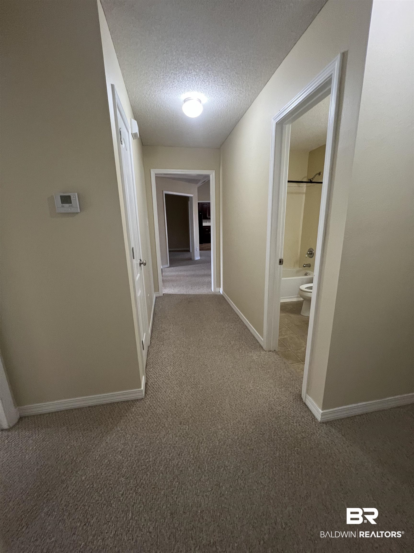 17793 Fancy Boulevard Foley, AL 36535 - Photo 11 of 34 Hall with a textured ceiling and carpet flooring