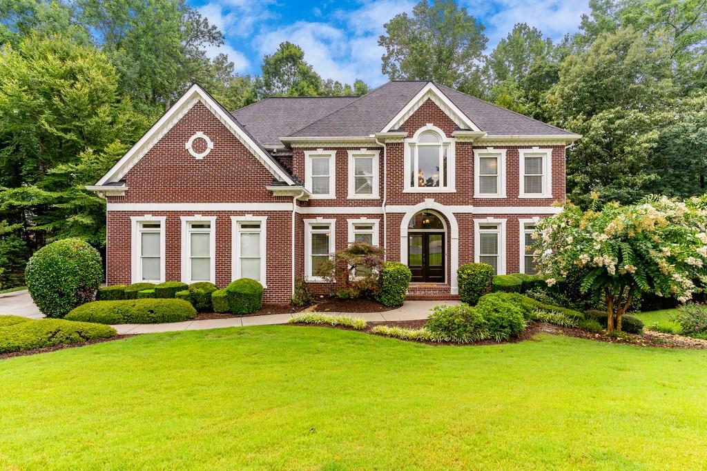 220 Redmond Ridge Circle Alpharetta, GA 30022 - Photo 1 of 1 a front view of a house with garden