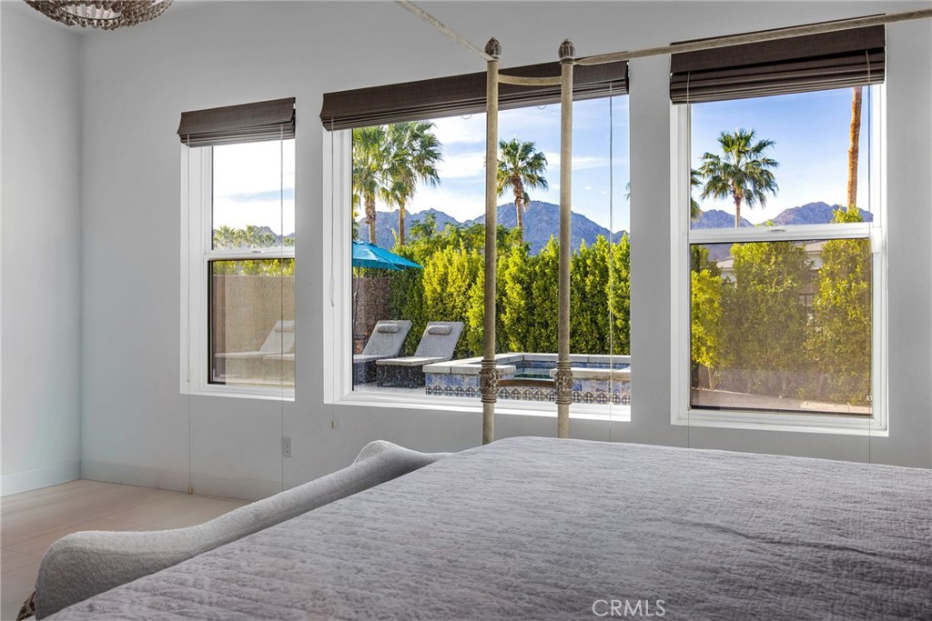 80440 Old Ranch Trail South La Quinta, CA 92253 - Photo 17 of 46 a bedroom with a large window and a bed