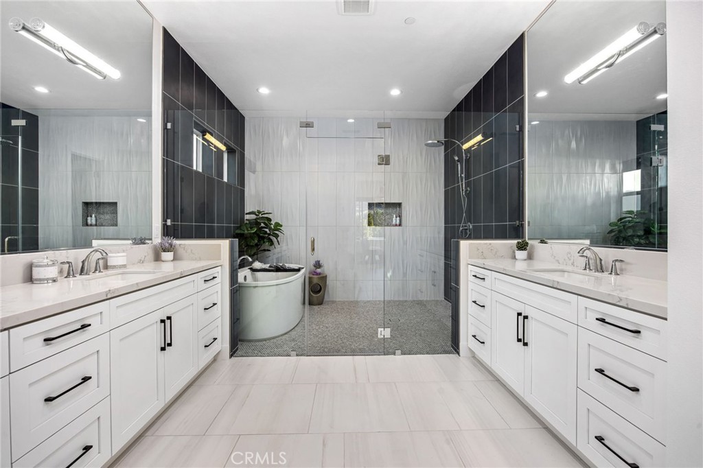 80440 Old Ranch Trail South La Quinta, CA 92253 - Photo 18 of 46 a large bathroom with a double vanity sink a large mirror and a shower