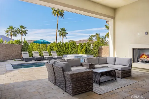 a view of a patio with couches and potted plants