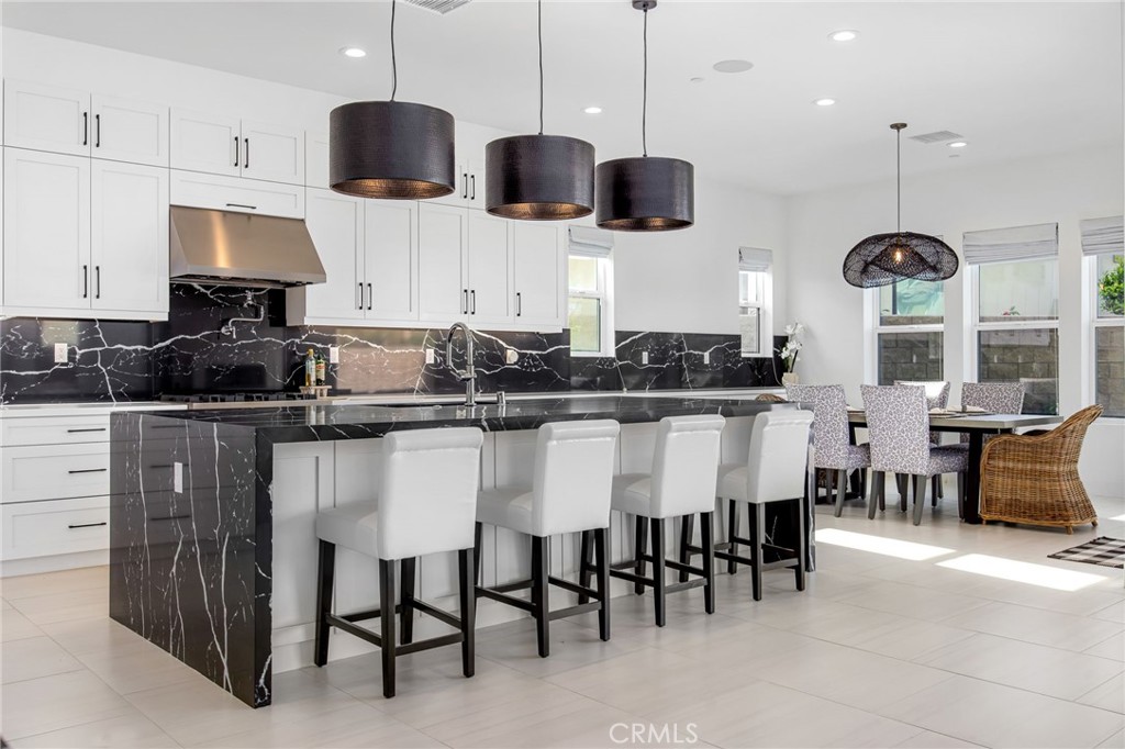 80440 Old Ranch Trail South La Quinta, CA 92253 - Photo 8 of 46 a kitchen with stainless steel appliances kitchen island granite countertop a table and chairs in it