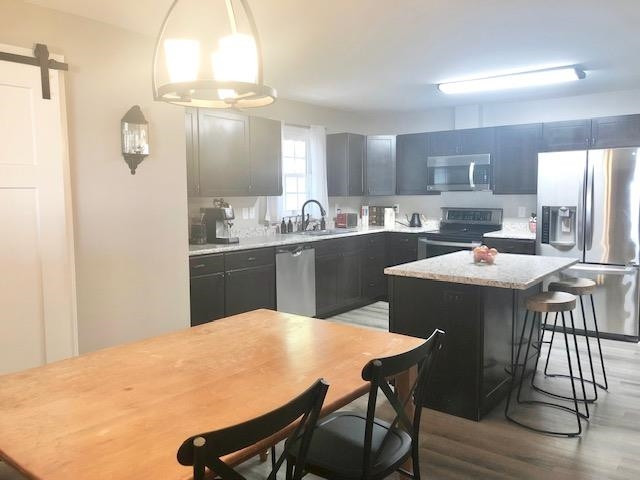 67 David Lane Roxboro, NC 27573 - Photo 5 of 22 a kitchen with a table chairs refrigerator and cabinets