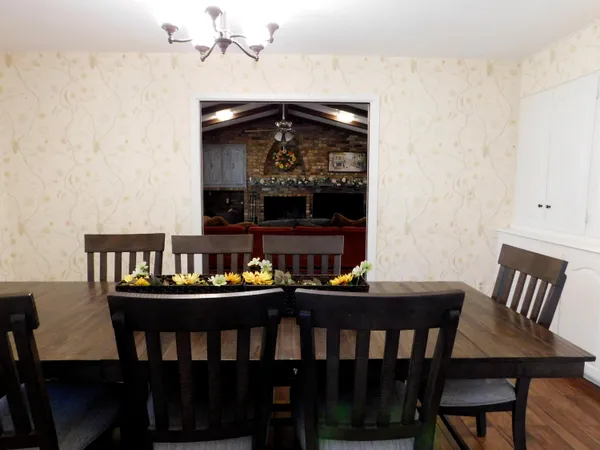 a living room with furniture wall paintings and a fireplace