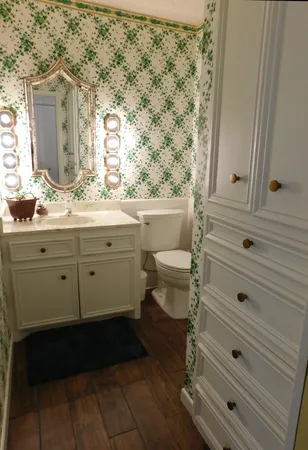 a spacious bedroom with a bed and a dresser