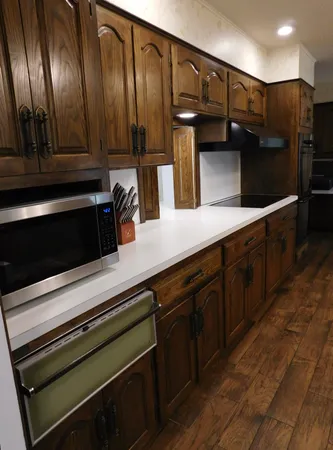 a kitchen with a sink refrigerator and cabinets