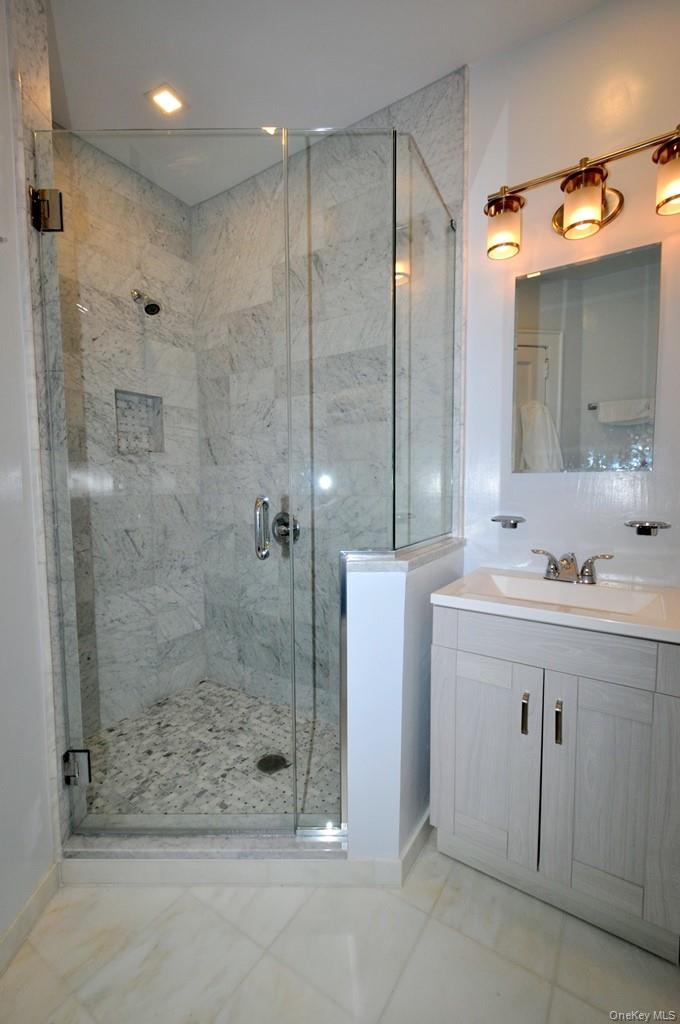 69 Harney Road, Unit 3A Scarsdale, NY 10583 - Photo 21 of 22 Fully renovated bath with marble tiled step-in shower.