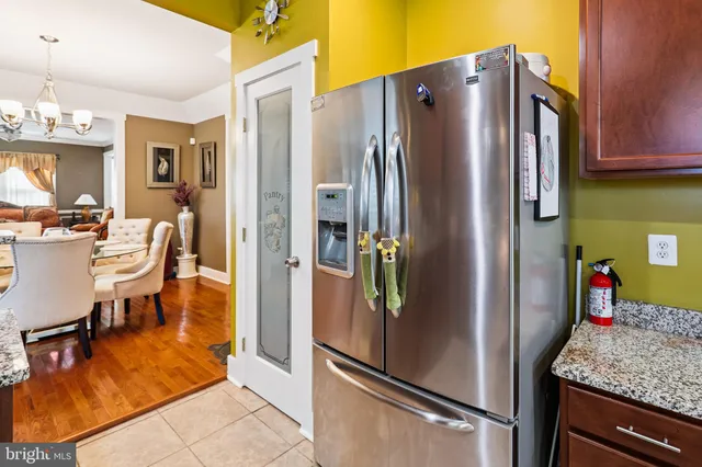 a metallic refrigerator freezer sitting in a kitchen