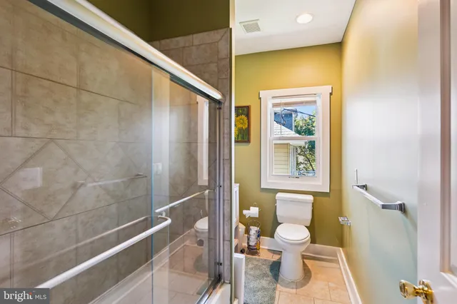 a bathroom with a toilet and a shower