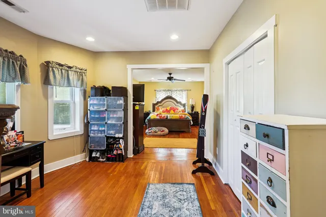 a bedroom with furniture and wooden floor
