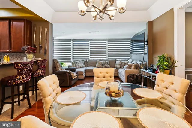 a living room with furniture fireplace and a large window