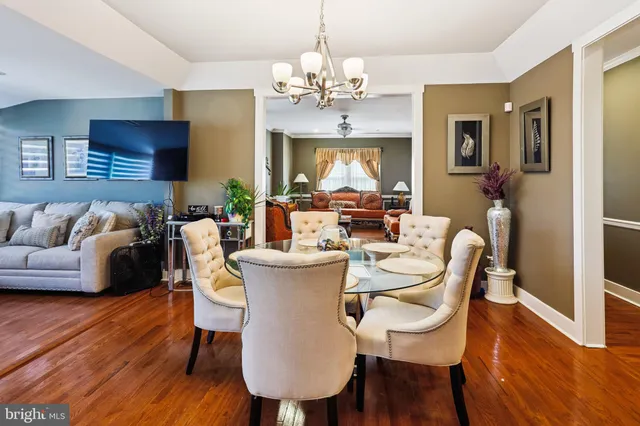 a view of a dining room with furniture wooden floor and chandelier