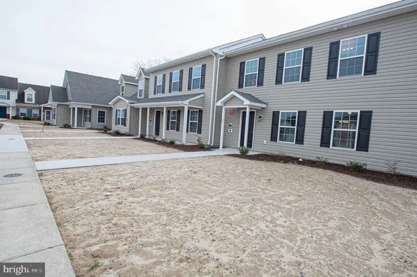 front view of a house with a dry yard