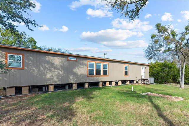 an aerial view of a houses with ocean view