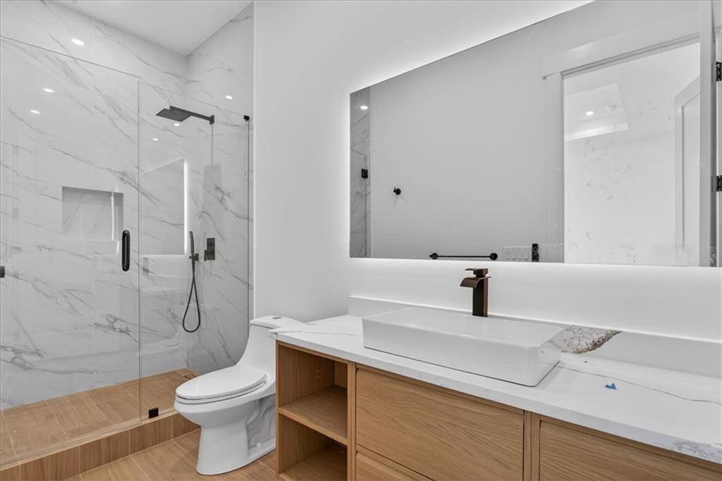 160 Railroad Street Canton, GA 30114 - Photo 26 of 35 a bathroom with a sink a toilet and shower