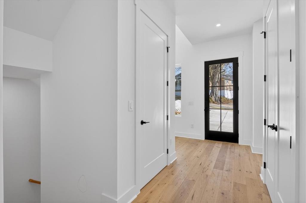 160 Railroad Street Canton, GA 30114 - Photo 7 of 35 a view of a hallway with wooden floor and a bathroom