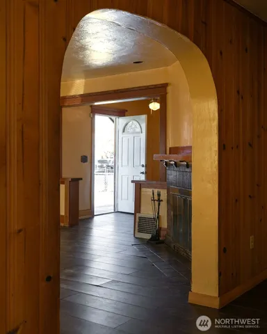 a view of a room with wooden floor chandelier and windows