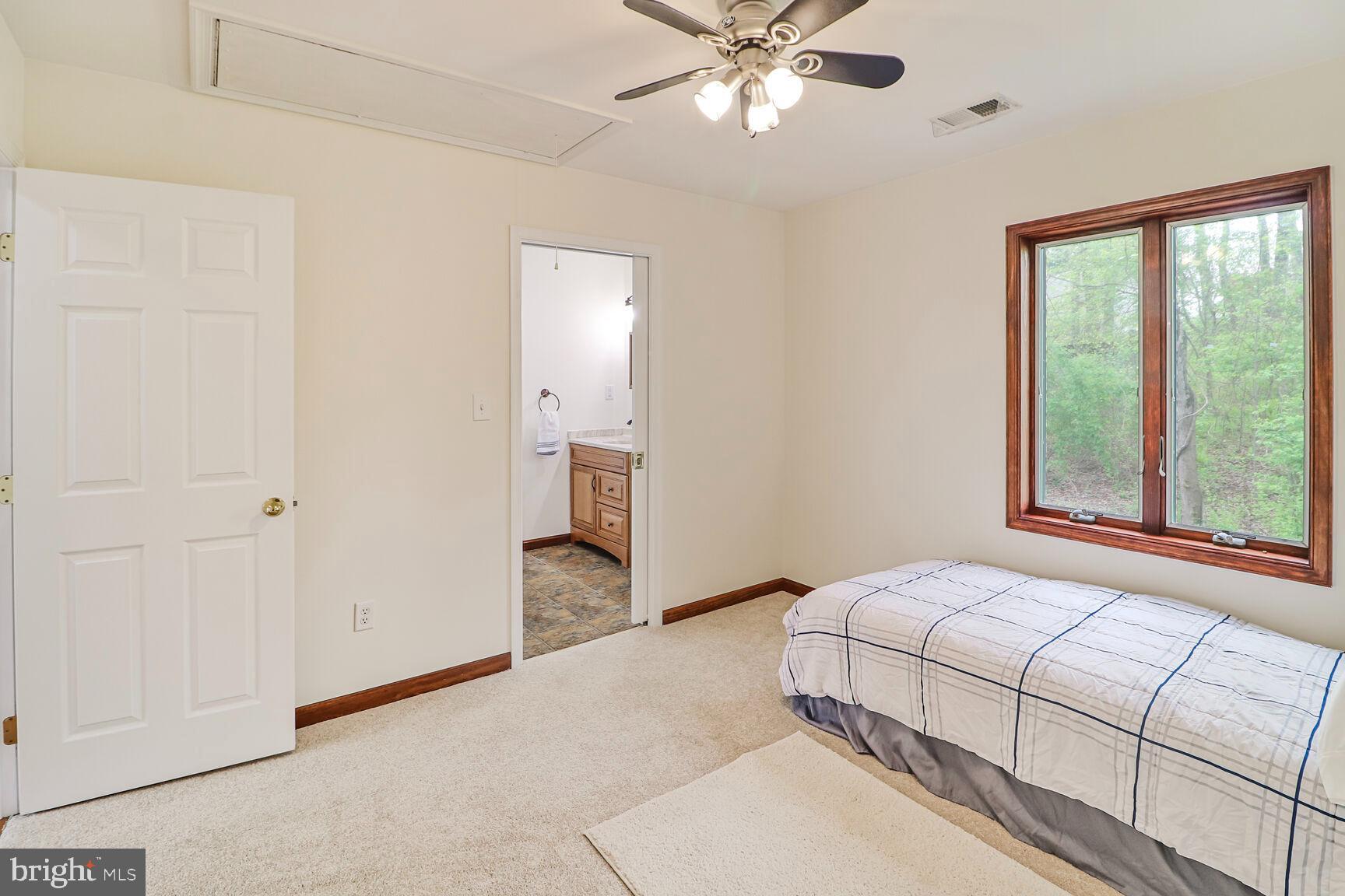 989 Ridge Road Finksburg, MD 21048 - Photo 40 of 50 a bedroom with a large bed and a chandelier