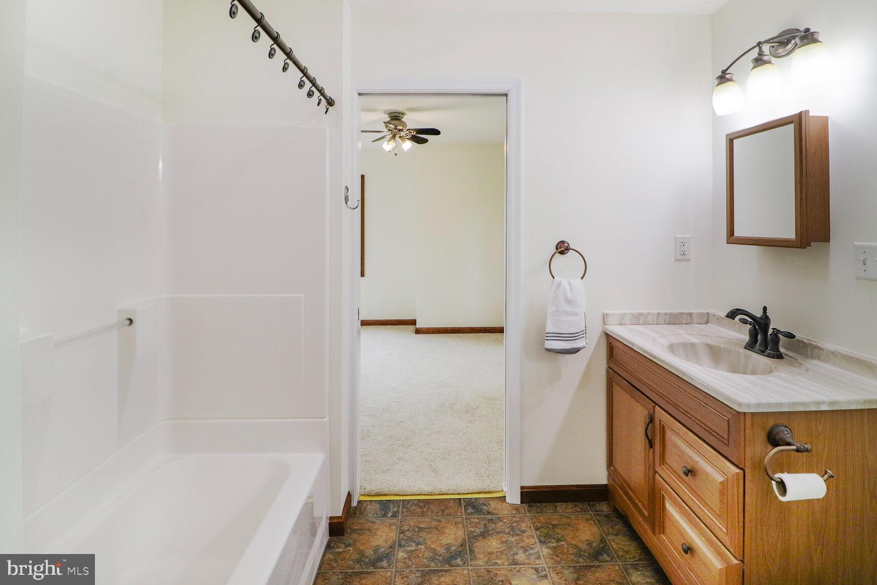 989 Ridge Road Finksburg, MD 21048 - Photo 41 of 50 a bathroom with a sink vanity granite tub shower and a mirror