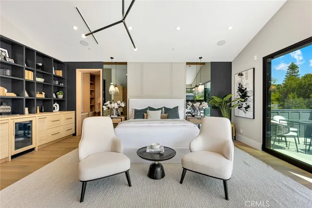 a view of a hallway with wooden floor and a cabinet