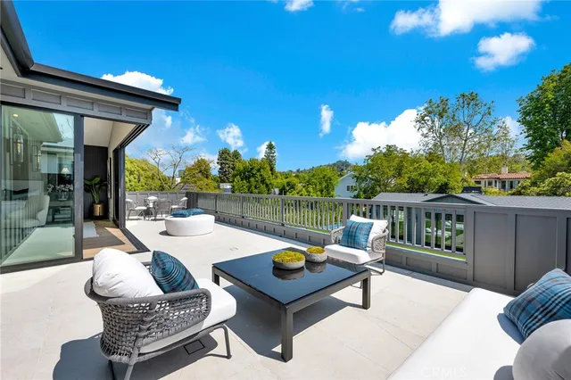 a living room with furniture a rug and a table