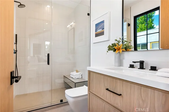 a view of a patio with couches table and chairs under an umbrella