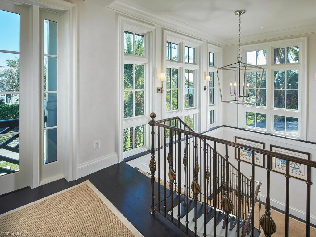 167 4th Street North Naples, FL 34102 - Photo 13 of 33 a view of a balcony with furniture and floor to ceiling window