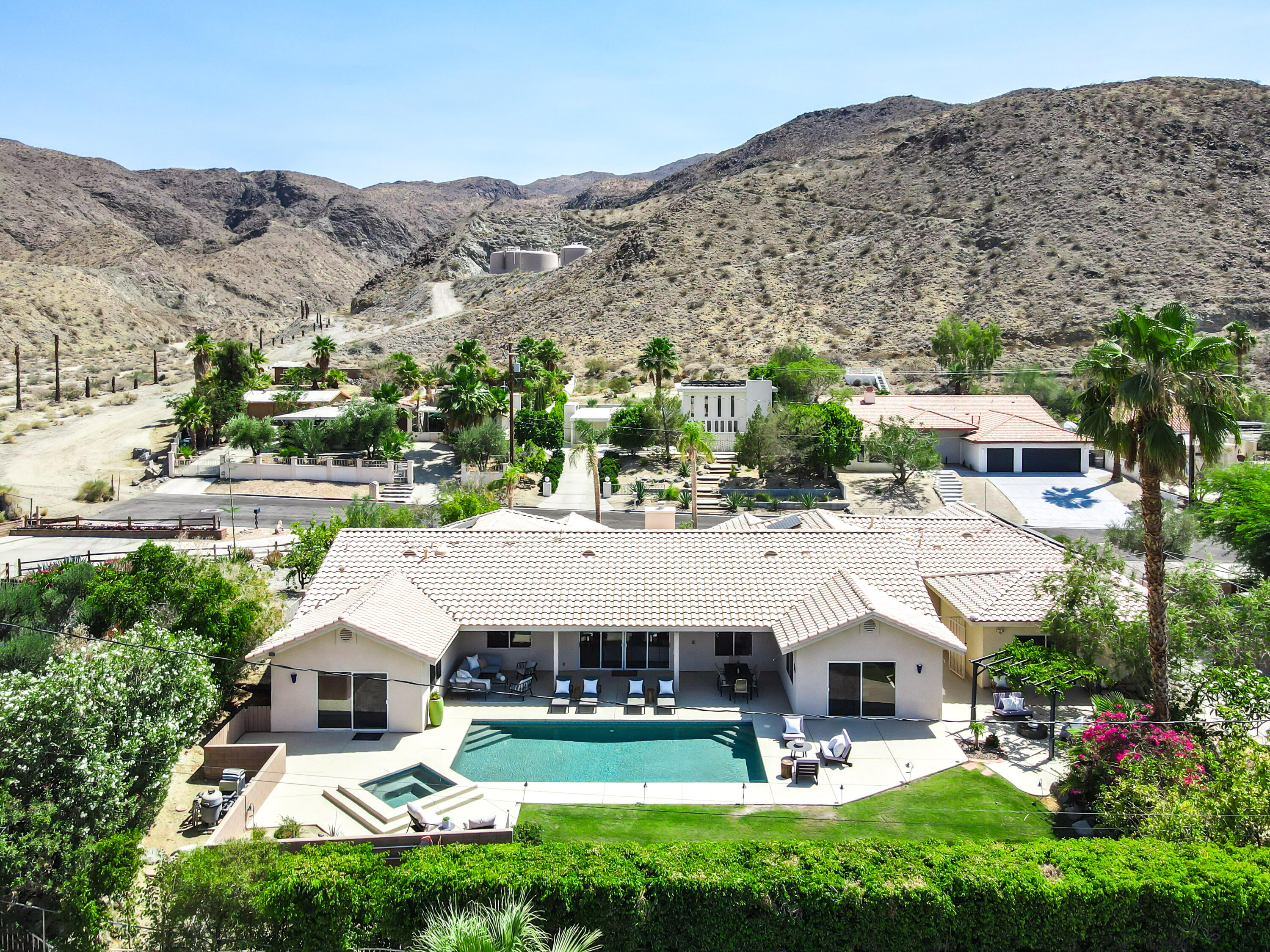 an aerial view of a house with swimming pool and a yard